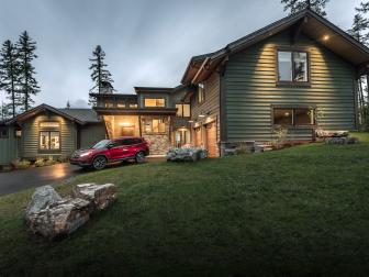 Natural landscaping in the front yard includes large stones that evoke the area’s natural beauty.